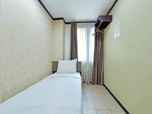 Postel nebo postele na pokoji v ubytování One Enigma Hotel