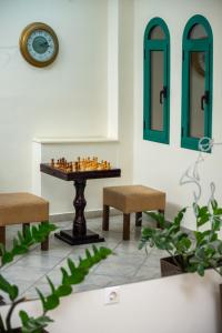 a room with a chess board on a table with benches at Konstantinos Hotel & Apartments 2 in Nydri