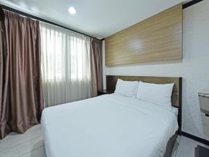Postel nebo postele na pokoji v ubytování One Enigma Hotel