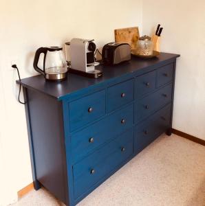 a blue dresser with a microwave on top of it at Simple Appartment in the Center of Burgdorf 64 m2 with private Parking - SMALL BATHROOM in Burgdorf