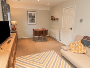 a living room with a couch and a table at 60B Castlegate in Berwick-Upon-Tweed