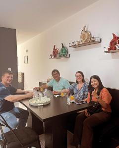 a group of people sitting around a table at Casa do Zafer in Sao Paulo