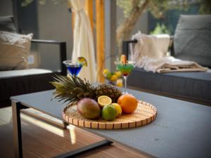 a plate of fruit on a table in a living room at Beachfront Bliss - Vortex4BB in Tisno