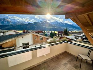 a balcony with a view of the mountains at mountain view in Piesendorf