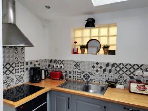 a kitchen with a sink and a counter top at LA PETITE MAISON in Beauvais