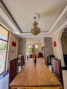 a dining room with a wooden table and chairs at Mad Vervet Backpackers Hostel in Addis Ababa