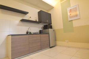 a kitchen with a stainless steel refrigerator in a room at KL Art Nouveau Suite, MRT, Free Parking, Self Check In in Petaling Jaya