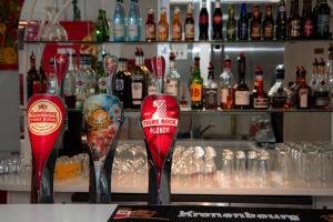 a bar with two red wine glasses on a counter at K Hotel in Strasbourg