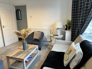 a living room with a couch and a table at Luxury Stays in Birkenhead