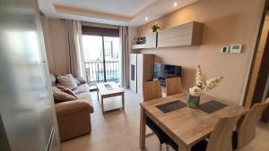 TV a/nebo společenská místnost v ubytování Apartamentos Vacacionales Joctis, 1º A