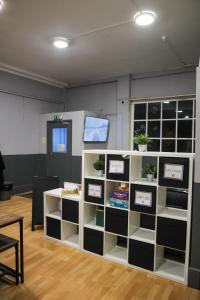 a room with shelves with potted plants on them at Onefam Waterloo 18-36 years old in London