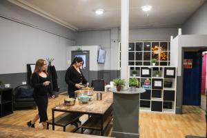two women standing in a room with a table at Onefam Waterloo 18-36 years old in London