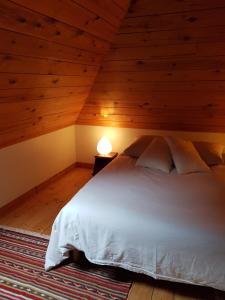 a bedroom with a white bed in a attic at Home Sweet Home in Brest