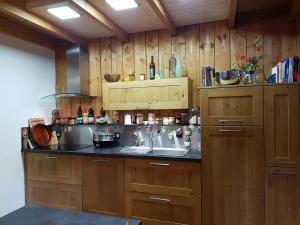 a kitchen with wooden walls and a sink and a counter at Home Sweet Home in Brest