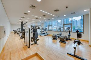 a gym with treadmills and cardio equipment in a building at Modern 2 Bedroom Suite Stunning view Sparkle Tower in Dubai