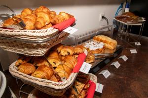 a bakery with baskets of bread and pastries on display at K Hotel in Strasbourg