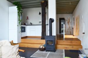 a living room with a wood stove in the middle at Ferienwohnung Winzerloft in Sulzfeld am Main