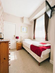 a bedroom with a bed and a window at The Western in St Ives