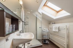 a bathroom with a sink and a skylight at Apartmenthaus - Erlebenswert Bauernhof Gruber in Sankt Lorenzen im Lesachtal +173 photos