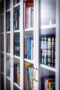 a book shelf filled with lots of books at Light modern Pallo apartment by the lake Saimaa in Lappeenranta