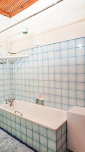 a bath tub in a bathroom with blue tiles at Naivasha TownHouse in Naivasha