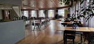 a restaurant with tables and chairs and a bar at Burning Bridge Motell & Vandrarhem in Götene
