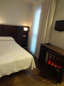 Łóżko lub łóżka w pokoju w obiekcie Hotel Irixo