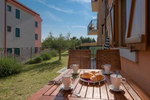 a table with a plate of croissants and drinks on it at Apartments Vallum in Bol
