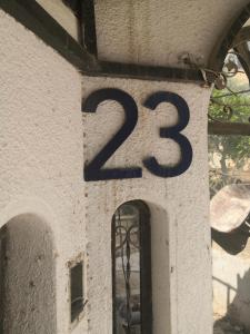 a clock on the side of a building with at white tulips studio in Jerash +48 photos