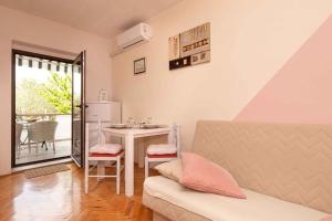 a living room with a table and a kitchen at Apartment in Vrbnik/Insel Krk 13613 in Vrbnik