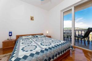 a bedroom with a bed and a large window at Apartment in Vrbnik/Insel Krk 13603 in Vrbnik