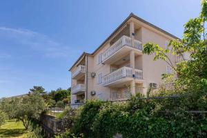 a large building with balconies on the side of it at Apartment in Vrbnik/Insel Krk 13603 in Vrbnik