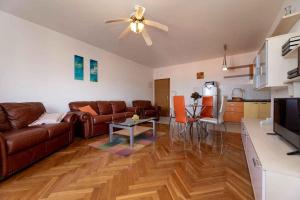 a living room with a couch and a ceiling fan at Apartment in Vrbnik/Insel Krk 13603 in Vrbnik