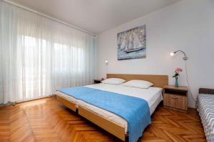 a bedroom with a large bed and a window at Apartment in Vrbnik/Insel Krk 13610 in Vrbnik