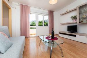 a living room with a couch and a glass table at Apartment in Vrbnik/Insel Krk 13610 in Vrbnik