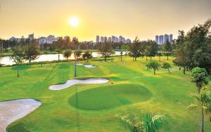 a golf course with the city in the background at Moon's Home in Ho Chi Minh City