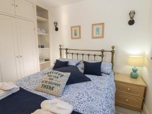 a bedroom with a bed with blue pillows at Grace's Retreat in Darlington