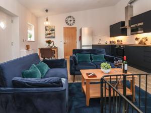 a living room with two blue couches and a table at Robins Nest in York