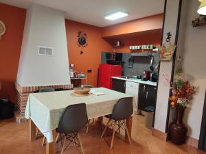 a kitchen with a table and chairs in a room at La Casita de Pedraza in Segovia