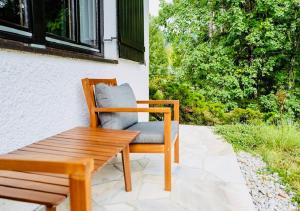 a wooden chair sitting next to a wooden table at Ferienhaus sHäuserl in Landl