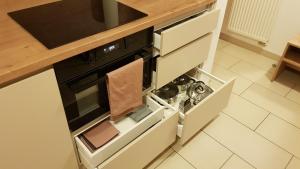 a kitchen with an open door of an oven at SKI Makov Apartmán 2L in Makov