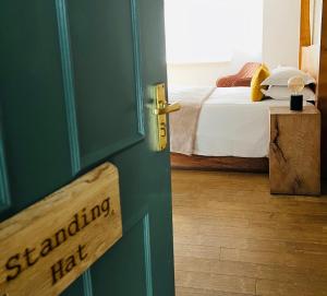 a door to a bedroom with a bed at Cottage Lodge Hotel in Brockenhurst