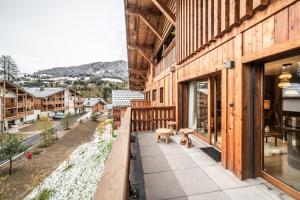 a balcony of a house with two dogs on it at Apartment Centaurea Megève - BY EMERALD STAY in Megève