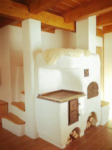 a large white oven in a room with stairs at Valachy chalupa Velké Karlovice in Velké Karlovice