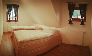 A bed or beds in a room at Valachy chalupa Velké Karlovice