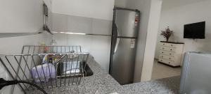a kitchen with a stainless steel refrigerator in a kitchen at Departamento muy confortable (monoambiente) 2 personas in Viedma