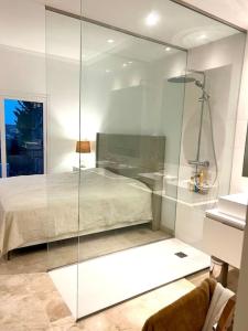a glass walled bedroom with a bed in a room at 0501 Paraíso Pueblo · Amazing new Apartment - 3 bed. 51 in Estepona