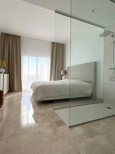 a bedroom with a large mirror and a bed at 0501 Paraíso Pueblo · Amazing new Apartment - 3 bed. 51 in Estepona