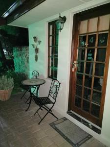 a patio with a table and chairs next to a window at A Cherry Lane Self Catering and B&B in Bloemfontein