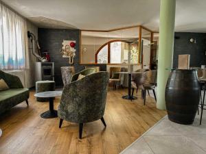 uma sala de estar com cadeiras, uma mesa e um sofá em Animae Natura Hotel & Chalet em Mezzana
